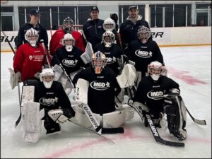 Hockey team posing on ice rink.